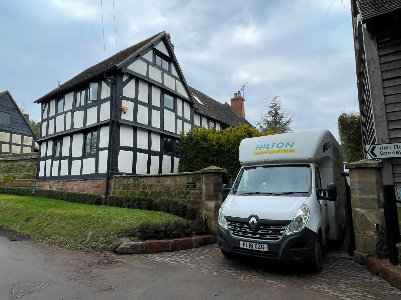 Hilton removal van outside a timber-framed house