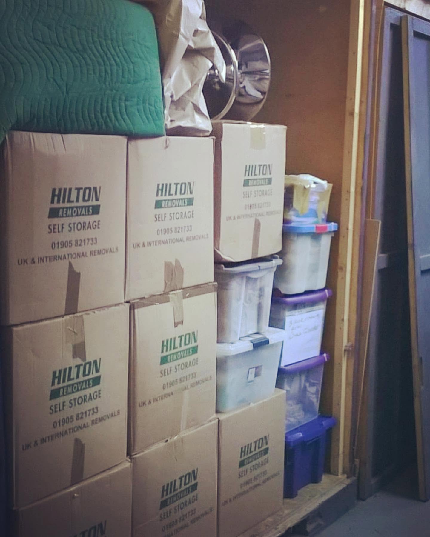 Hilton boxes and plastic crates packed alongside protected belongings
